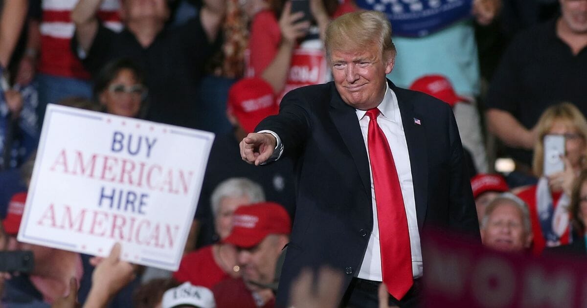 President Donald Trump points to a supporter during a rally at the International Air Response facility on Oct 19, 2018 in Mesa, Arizona.
