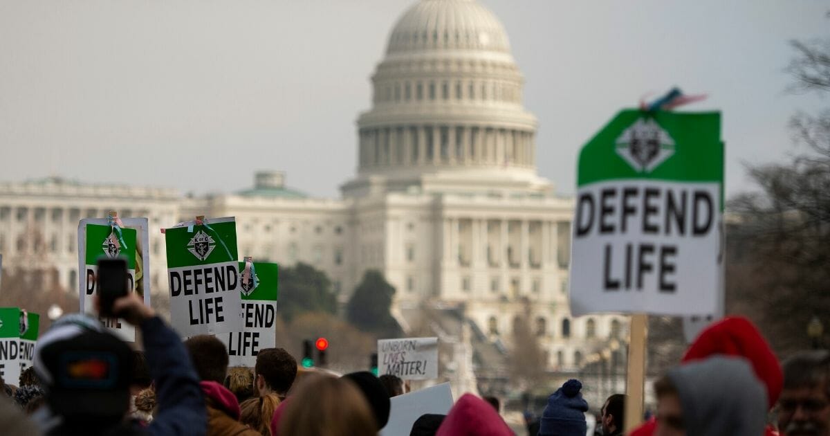 People carry signs during the annual "March for Life" in Washington, D.C.