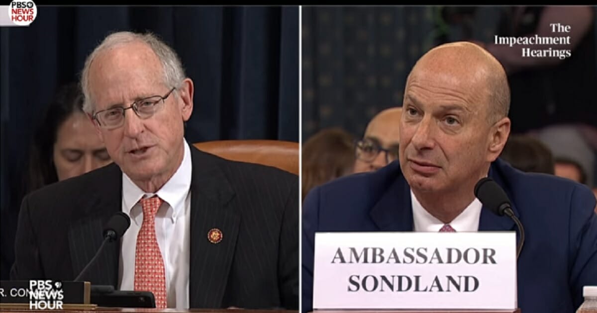 Republican Rep. Mike Conway, left, questions European Union Ambassador Gordon Sondland, right, during the House Intelligence Committee's impeachment hearings on Wednesday.