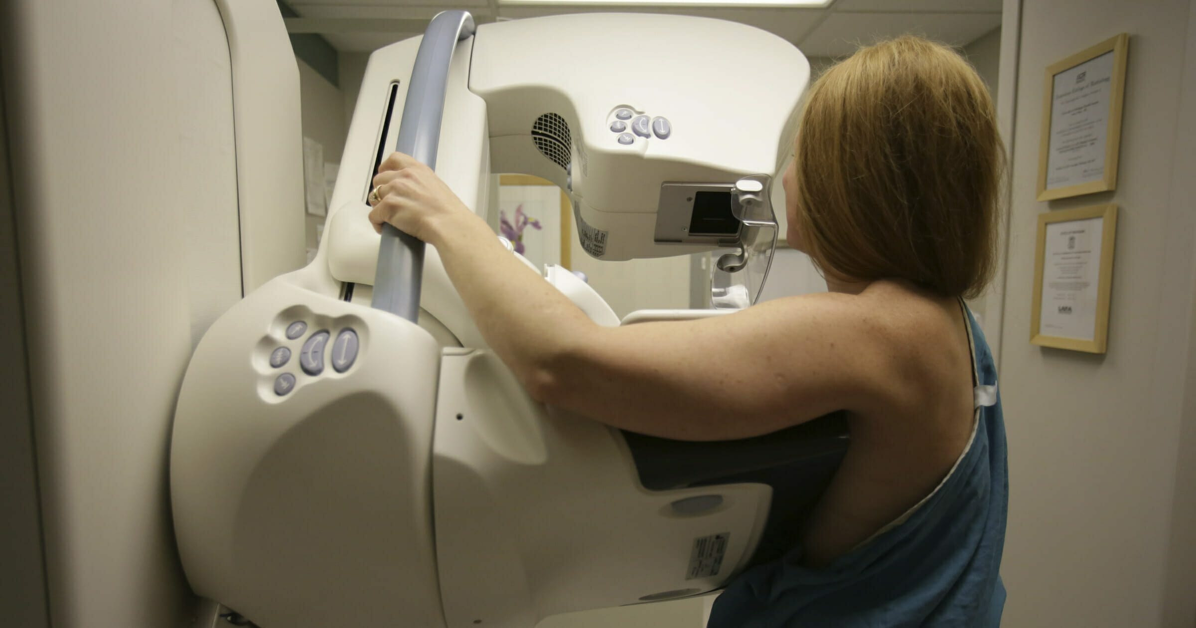 In this May 22, 2015, photo, a woman gets a mammogram at the University of Michigan Cancer Center in Ann Arbor, Michigan.