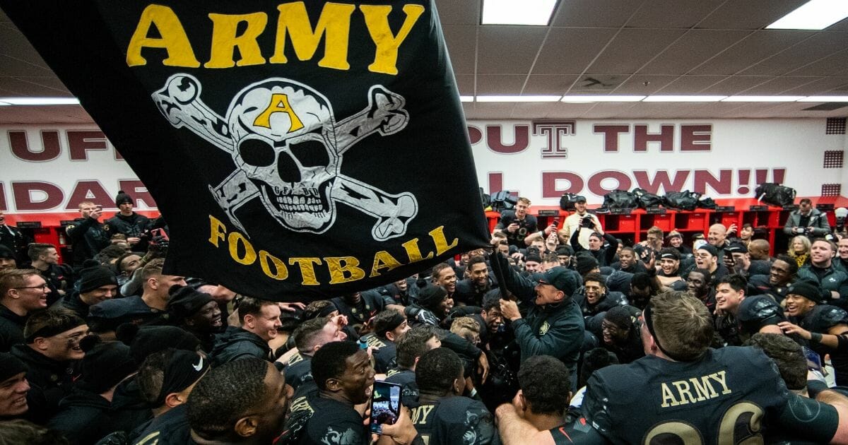 Jeff Monken, head coach of the Army Black Knights, waves a flag in the locker room after defeating the Navy Midshipmen at Lincoln Financial Field on Dec. 8, 2018, in Philadelphia, Pennsylvania.