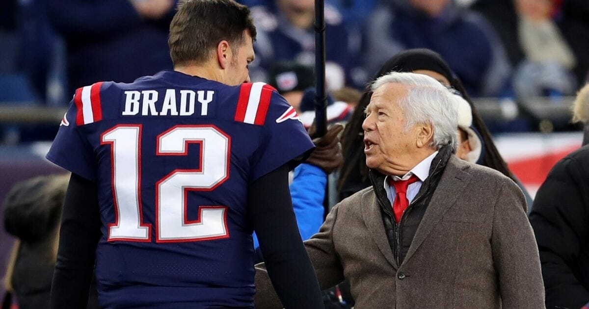 New England Patriots owner Robert Kraft, right, talks with quarterback Tom Brady before the team's game against the Kansas City Chiefs at Gillette Stadium in Foxborough, Massachusetts, on Dec. 8, 2019.