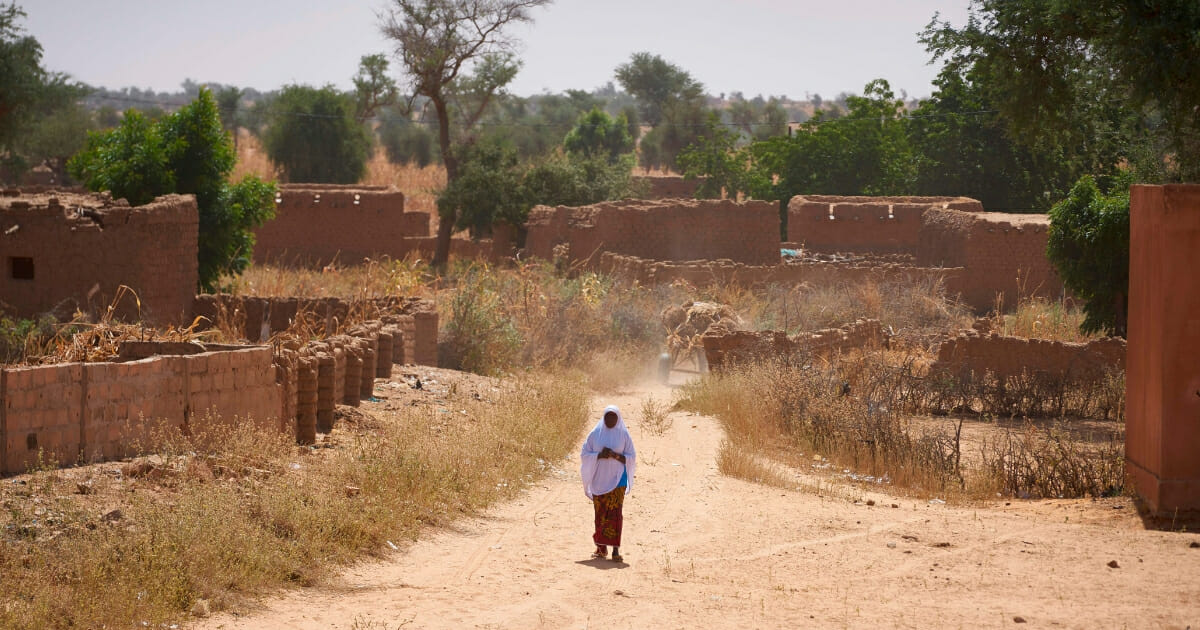 A Burkinabe woman observes the passage of French army vehicles in a village in northern Burkina Faso on Nov. 15, 2019.