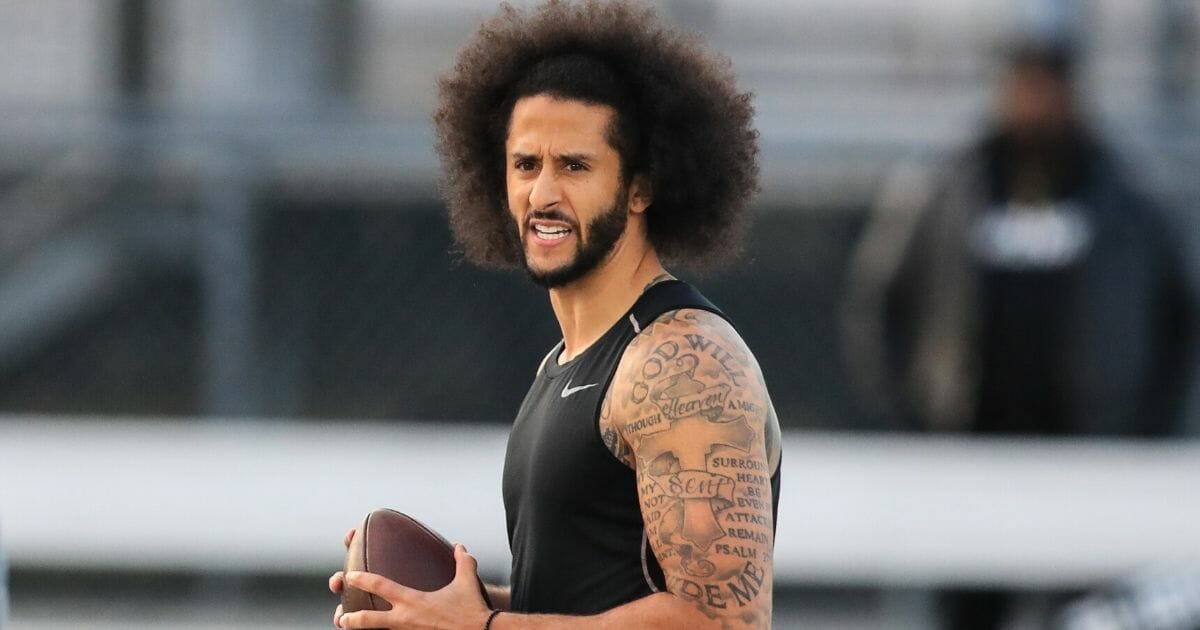 Colin Kaepernick looks to make a pass during a private NFL workout held at Charles R Drew high school on Nov. 16, 2019, in Riverdale, Georgia. Due to disagreements between Kaepernick and the NFL the location of the workout was abruptly changed.