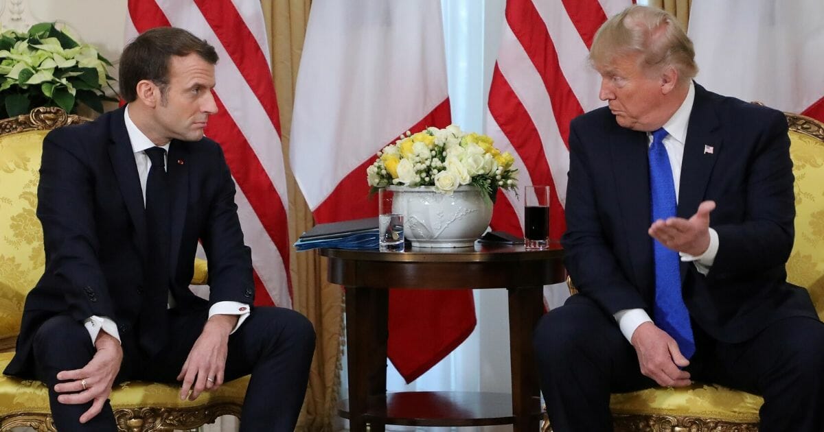 President Donald Trump, right, and French President Emmanuel Macron react as they talk during their meeting at Winfield House, London, on Dec. 3, 2019.