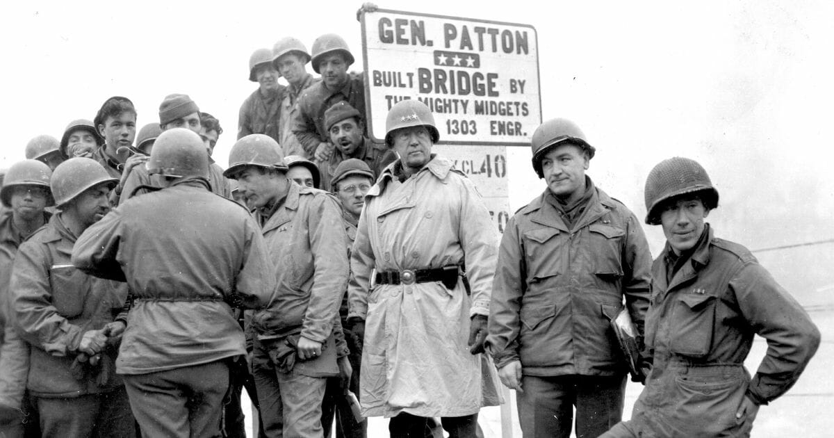 American military commander Lieutenant General George S. Patton -- center, in helmet with three stars -- commander of the 3rd Army, visits men of 1303rd Engineers, whose completed bridge across the Sauer River linked Luxembourg and Germany, on Feb. 20, 1945.