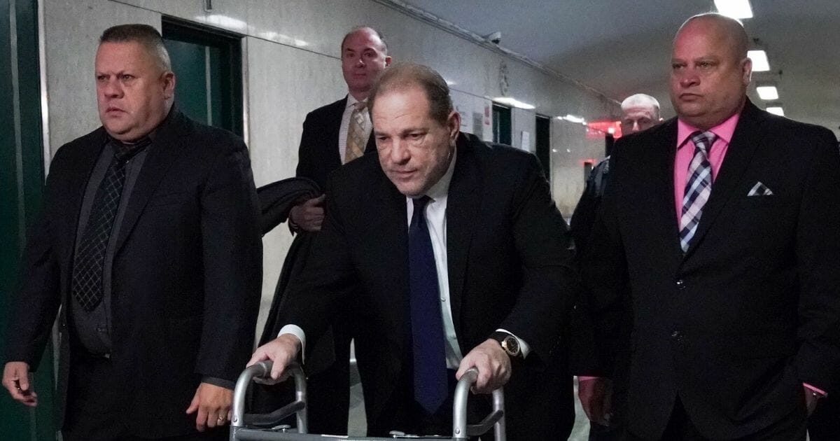 Harvey Weinstein, center, leaves Manhattan Criminal Court, using a walker, following a hearing on Dec. 11, 2019, in New York.