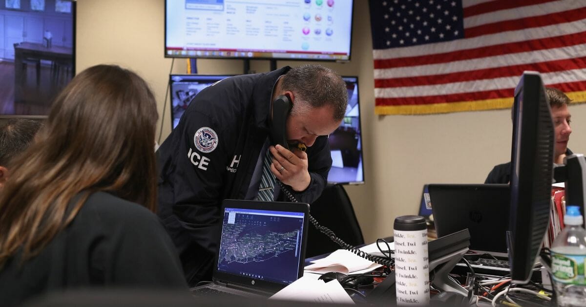 ICE agents working in a control center