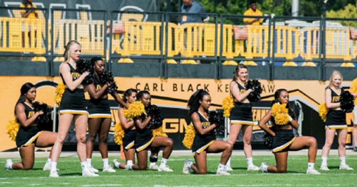 Kennesaw State University cheerleaders kneel in protest during the national anthem before a 2017 game.
