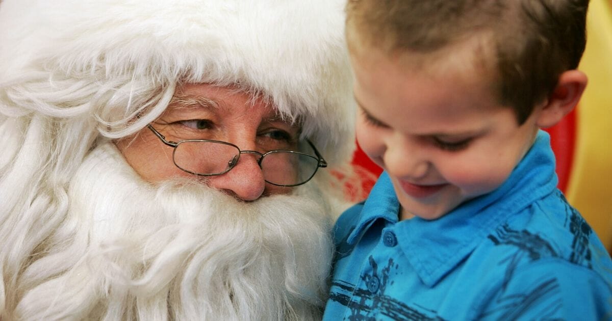 A young boy visits Santa Claus at Stanhope Gardens Shopping Centre in Sydney, Australia.