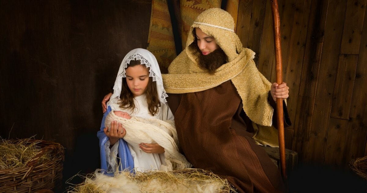 Children re-enact the nativity scene in the stock photo above.