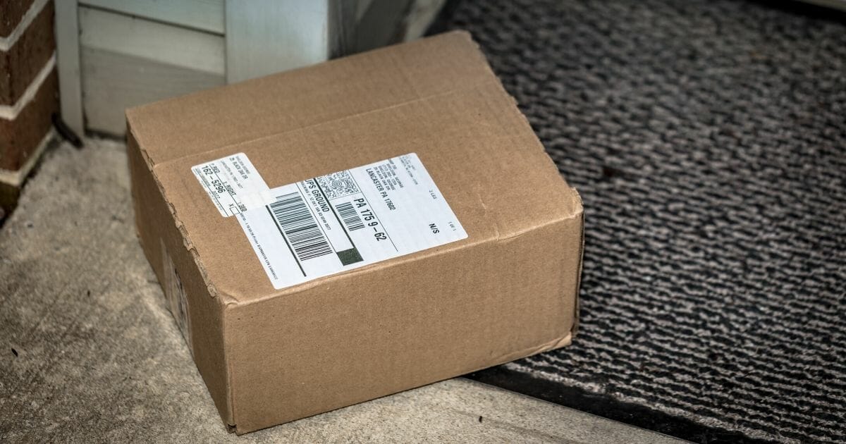 A stock photo of a package sitting on a porch is seen above. One woman came home expecting to find her delivered package but got a thank-you note from the thief instead.