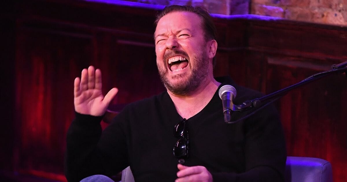 Comedian and actor Ricky Gervais laughs.