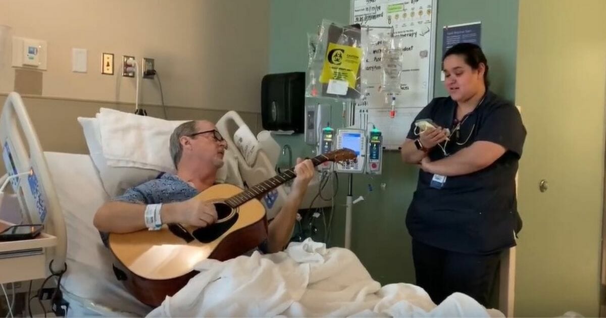 Man plays guitar for nurse