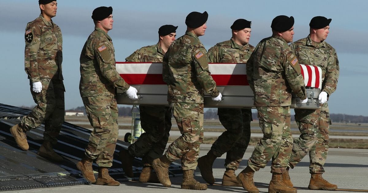 A U.S. Army carry team moves the remains of U.S. Army Sgt. 1st Class Michael Goble during a dignified transfer at Dover Air Force Base in Delaware on Dec. 25, 2019
