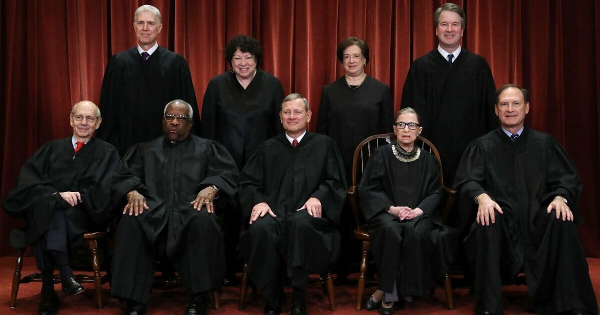 The Supreme Court justices pose for their official portrait in the East Conference Room at the Supreme Court building on Nov. 30, 2018, in Washington, D.C.