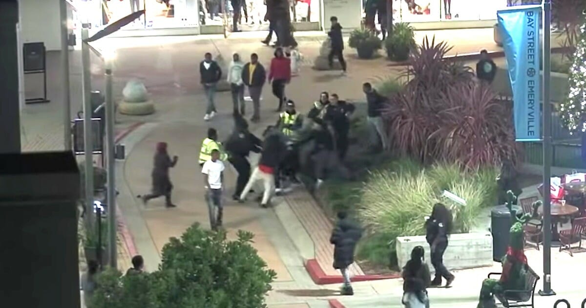 Teenagers attack an off-duty police officer on Black Friday at the Bay Street Mall in Emeryville near Oakland, California.