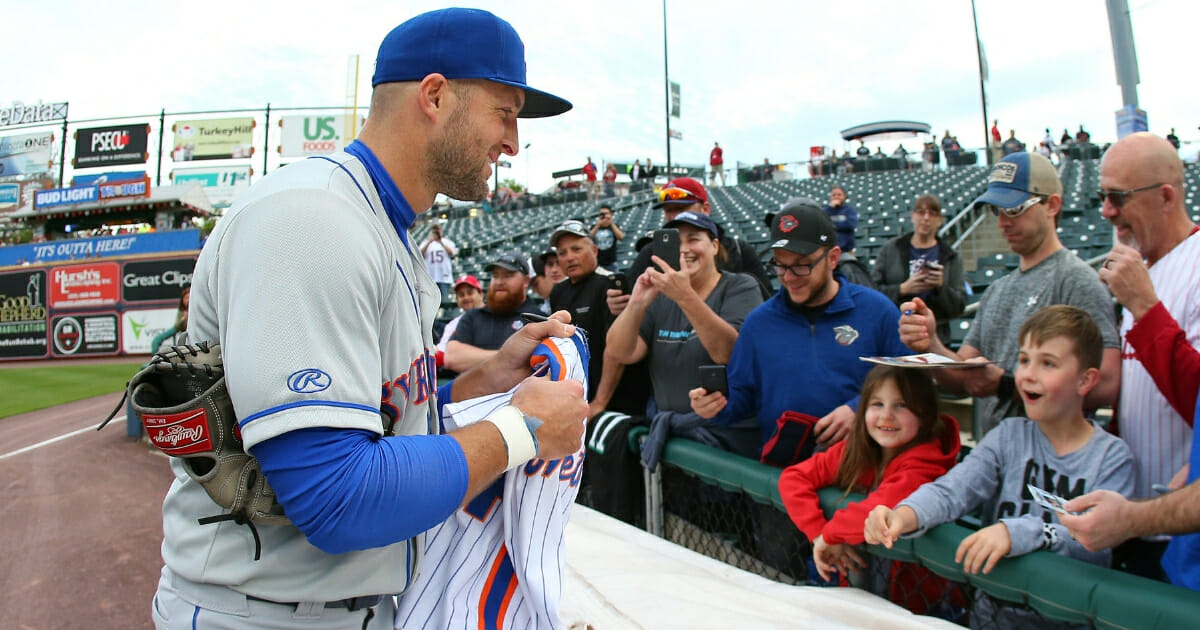Tim Tebow of the Triple-A Syracuse Mets signs autographs before a game against the Lehigh Valley Iron Pigs on April 30, 2019, at Coca Cola Park in Allentown, Pennsylvania.