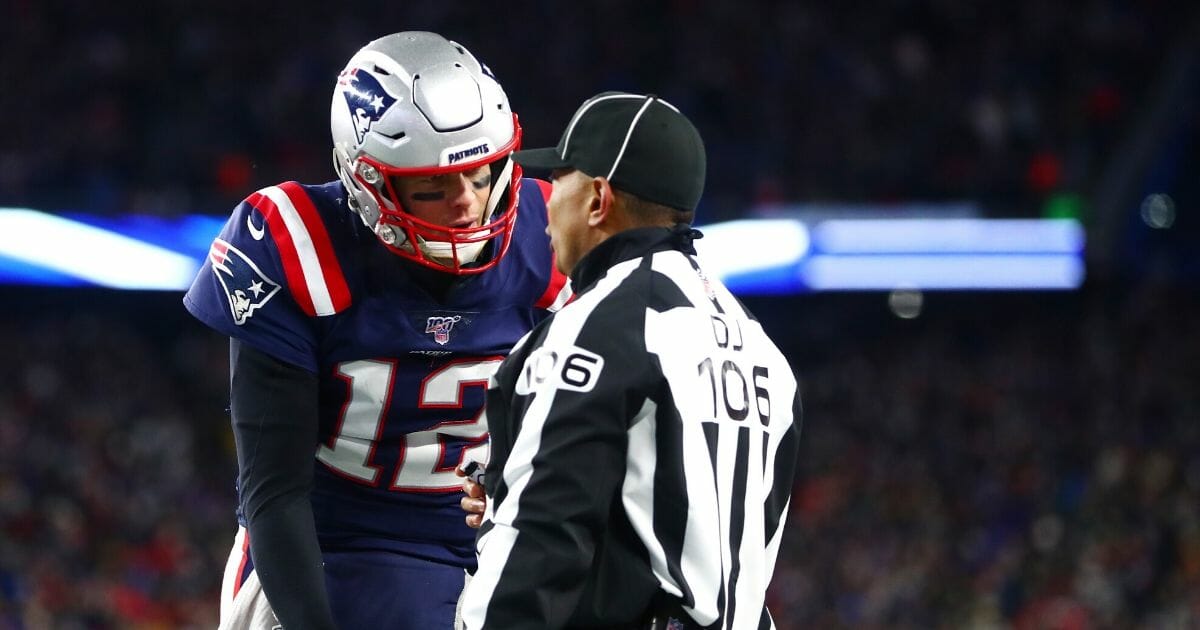 Tom Brady #12 of the New England Patriots argues a call with head linesman Wayne  Mackie during the fourth quarter of the game between the New England Patriots and the Kansas City Chiefs at Gillette Stadium on Dec. 8, 2019, in Foxborough, Massachusetts.