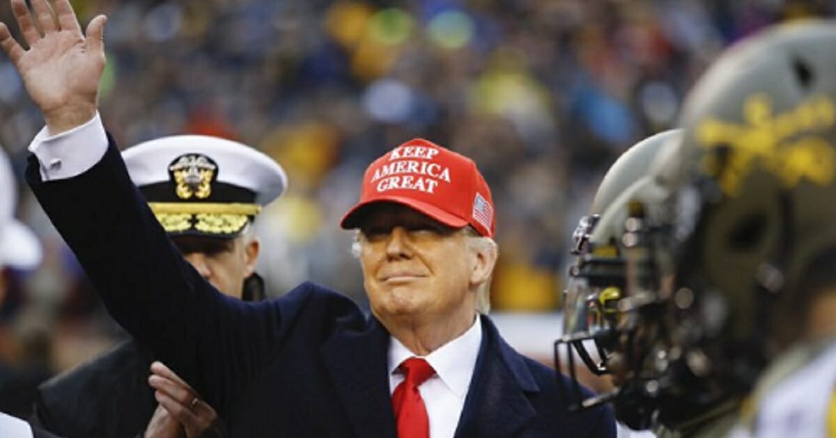 President Donald Trump waves to the crowd Saturday at the Army-Navy game at Lincoln Financial Field in Philadelphia.
