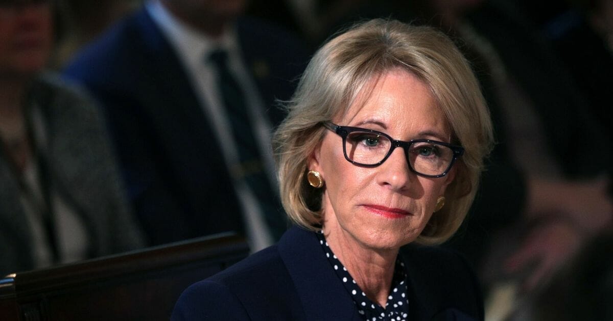 Secretary of Education Betsy DeVos listens during an Interagency Working Group on Youth Programs meeting at the State Dining Room of the White House on March 18, 2019, in Washington, D.C.