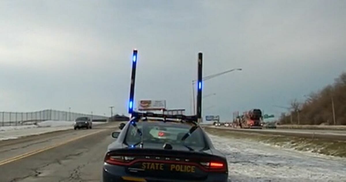 Police cruiser with vertical light bars installed.