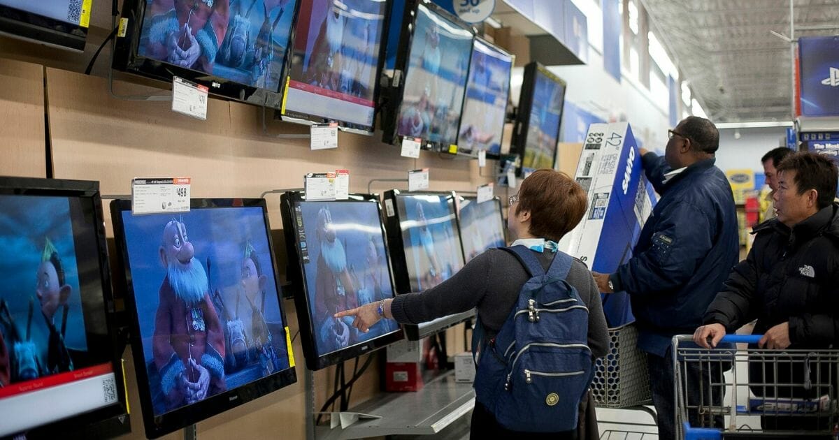 Black Friday shoppers eye televisions in a Quincy, Massachusetts,