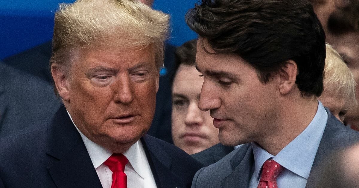President Donald Trump listens as Canadian Prime Minister Justin Trudeau speaks at the NATO summit in England on Wednesday.
