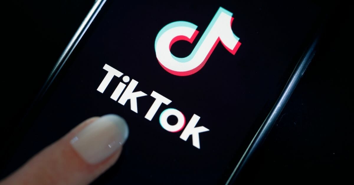 A cell phone showing the TikTok logo.
