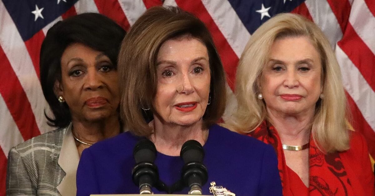 House Nancy Pelosi, wearing a nose bandage, appears Tuesday during a Capitol Hill news conference to announce articles of impeachment against President Donald Trump.