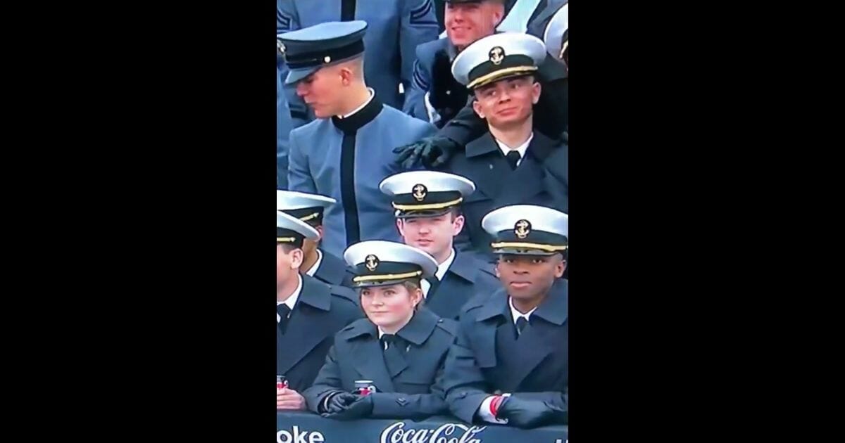 A midshipman in the stands at the Army-Navy game on Dec. 14, 2019, displays a hand symbol that some on Twitter decried as a "white power sign."