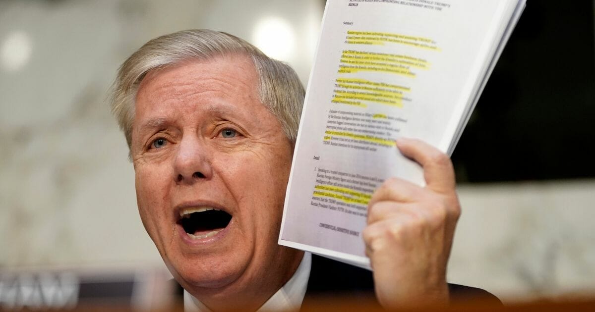 Senate Judiciary Committee Chairman Lindsey Graham holds up a copy of the Steele dossier as Michael Horowitz, inspector general for the Justice Department, testifies before the Senate Judiciary Committee in the Hart Senate Office Building on Dec. 11, 2019, in Washington, D.C.