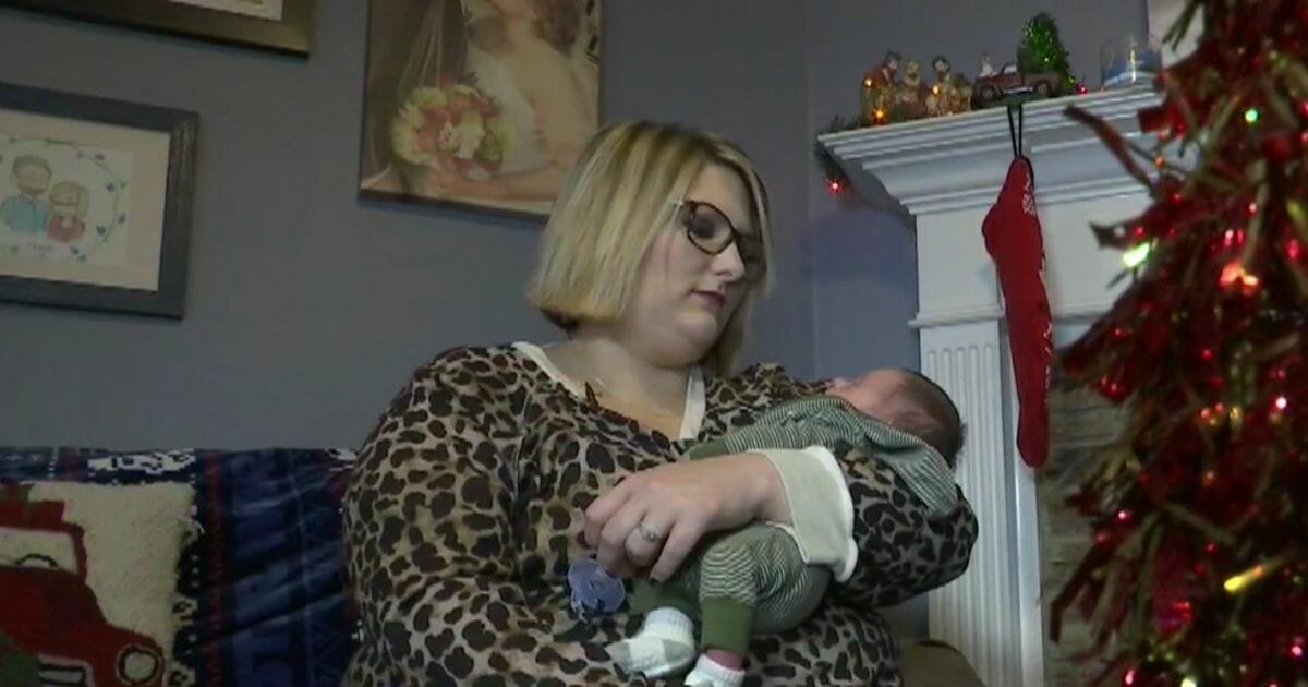 New mom Lauren Chalk holds her newborn baby, who was born just nine days after Chalk discovered she was pregnant.