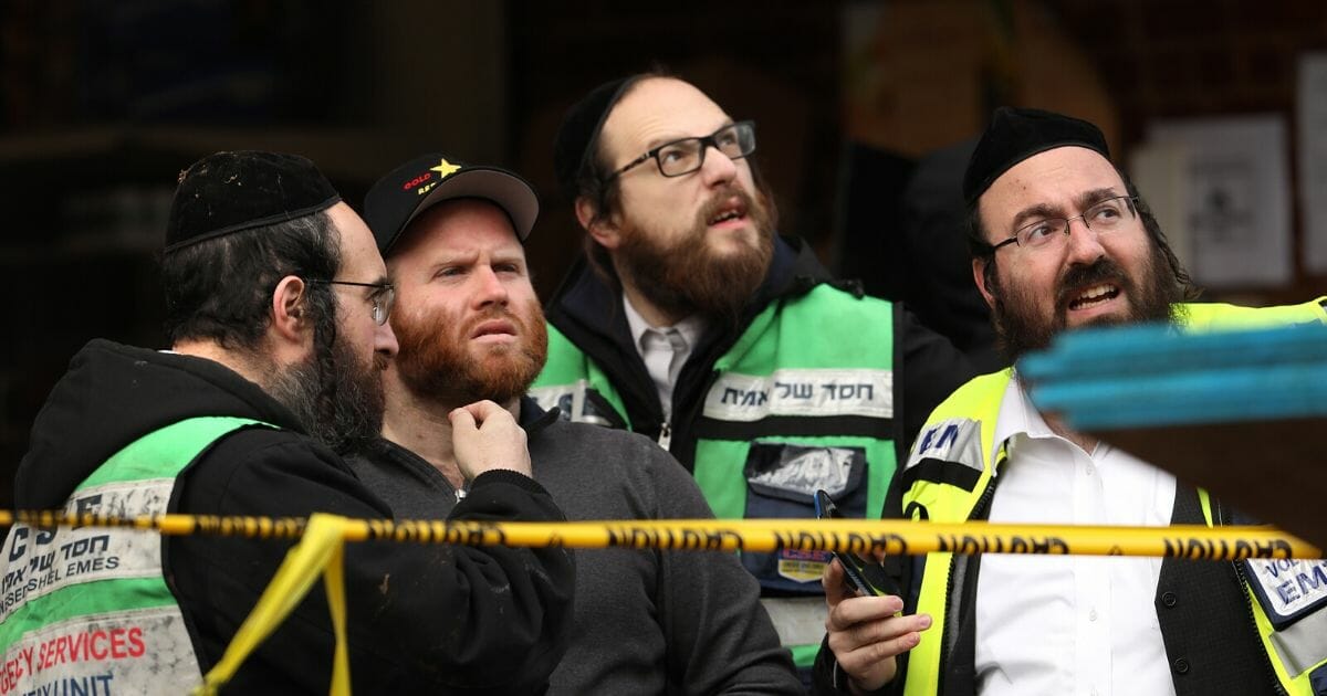 Recovery and clean-up crews work the scene in the aftermath of a mass shooting at the JC Kosher Supermarket on Dec. 11, 2019, in Jersey City, New Jersey.