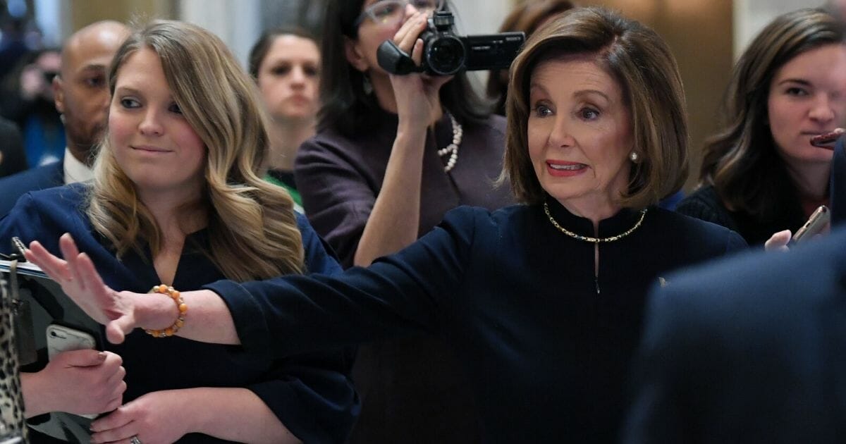 House Speaker Nancy Pelosi walks to the House floor Wednesday before debate on two articles of impeachment against President Donald Trump. (