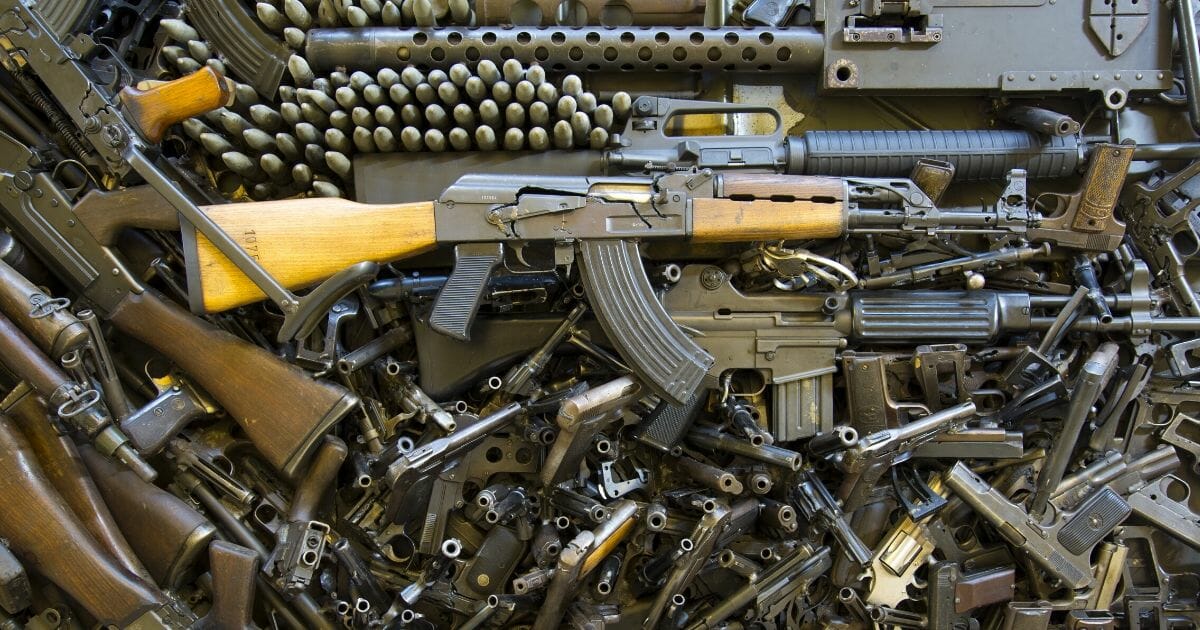 Stock image of a pile of firearms.