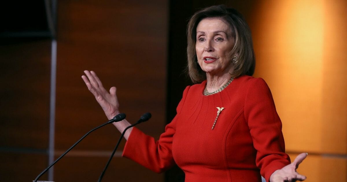 House Speaker Nancy Pelosi gestures Thursday during a news conference on the day after the House approved articles of impeachment against President Donald Trump.