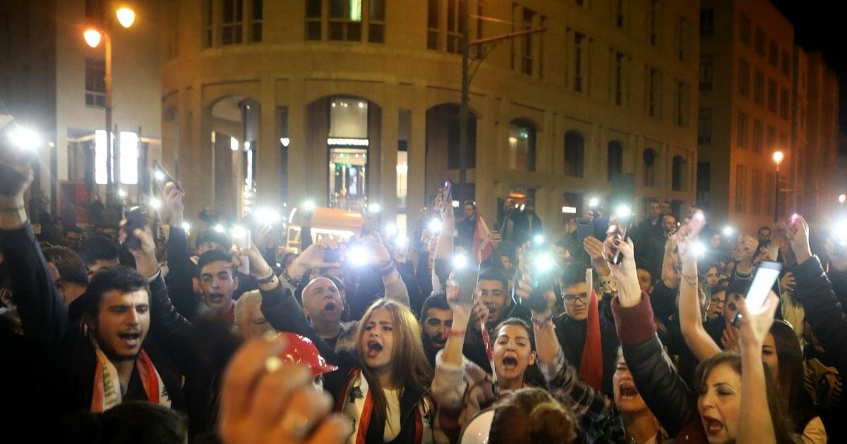 Lebanese anti-corruption protesters shout slogans outside the parliament to denounce the nomination of Prime Minister-designate Hassan Diab in Beirut on Dec. 19, 2019.