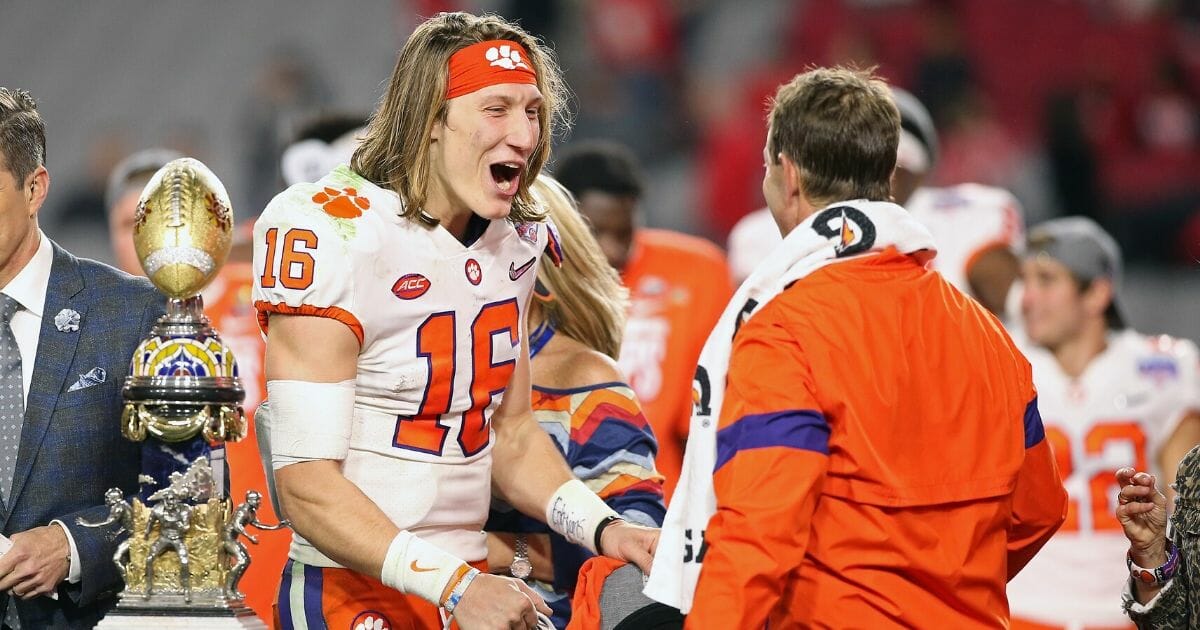 Clemson Tigers quarterback Trevor Lawrence celebrates his teams 29-23 win over the Ohio State Buckeyes in the College Football Playoff Semifinal at the PlayStation Fiesta Bowl at State Farm Stadium on Saturday.