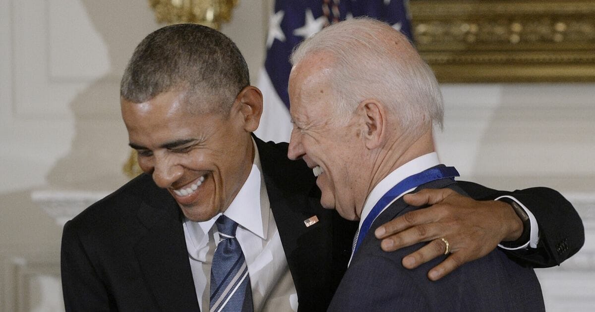 Then-President Barack Obama and Vice President Joe Biden share a laugh in January 2017 after Obama presented Biden with the Medal of Freedom.