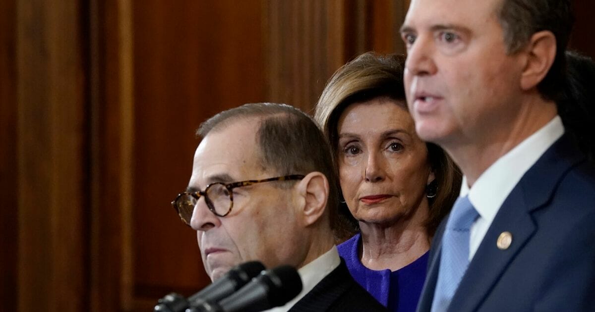 Speaker of the House Nancy Pelosi listens as Reps. Adam Schiff of California, right, and Jerry Nadler of New York announce the next steps in the House impeachment inquiry at the U.S. Capitol on Dec. 10, 2019 in Washington, D.C.