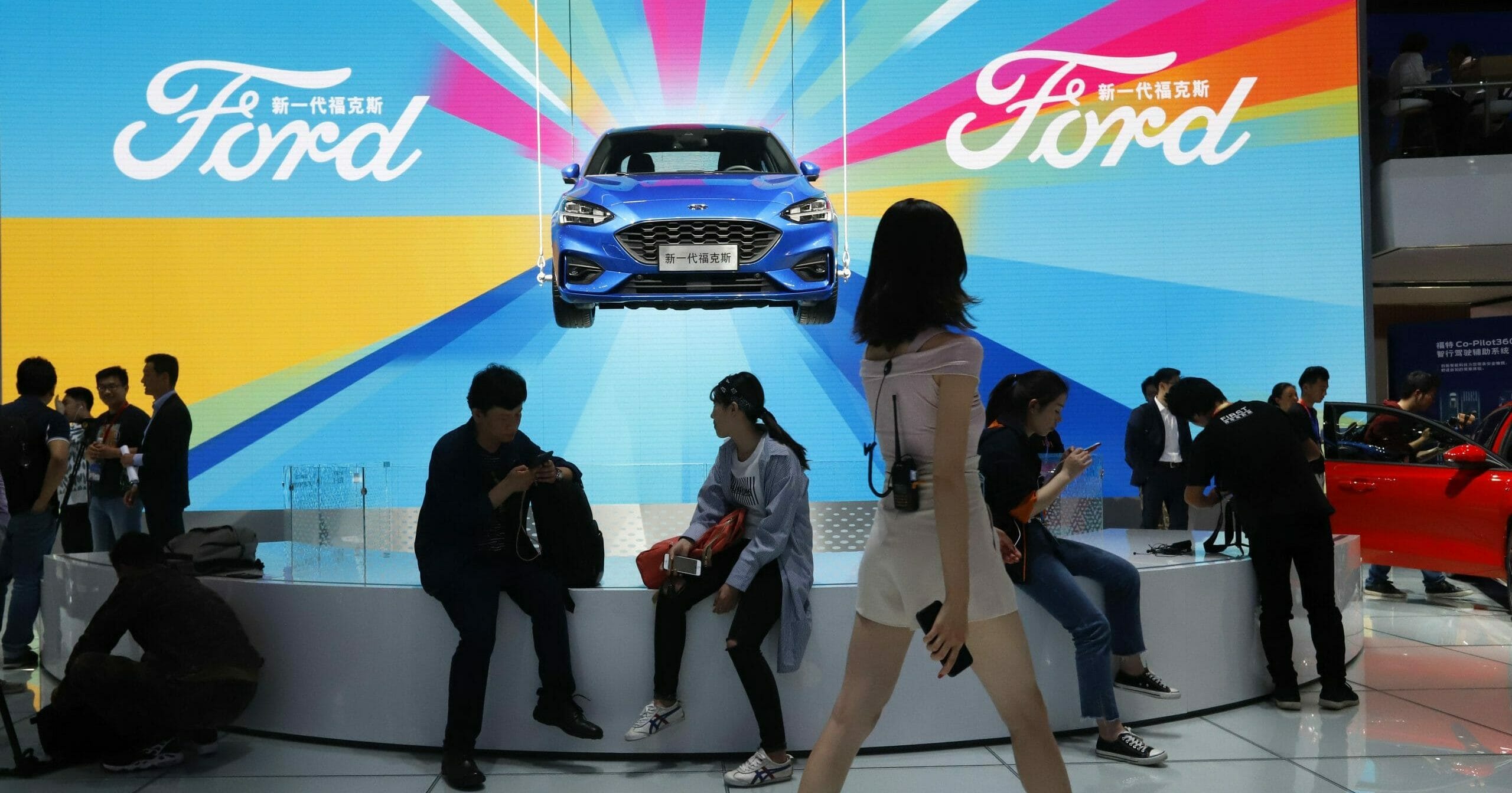 Attendees visit the Ford booth during the Auto China 2018 show held in Beijing on April 25, 2018.