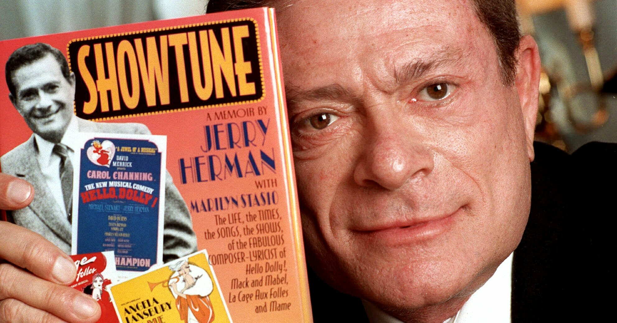 Composer Jerry Herman displays his book "Showtune" Nov. 19, 1996, in New York.