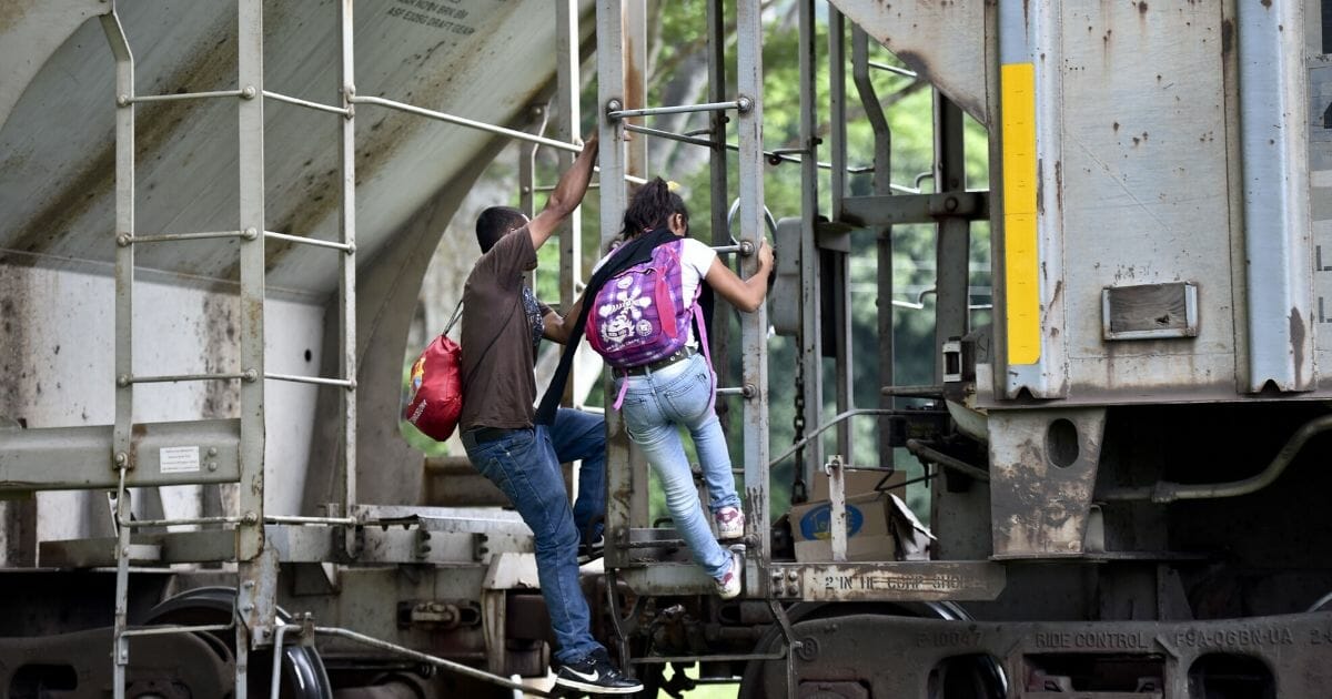 illegal immigrants boarding a train in Mexico