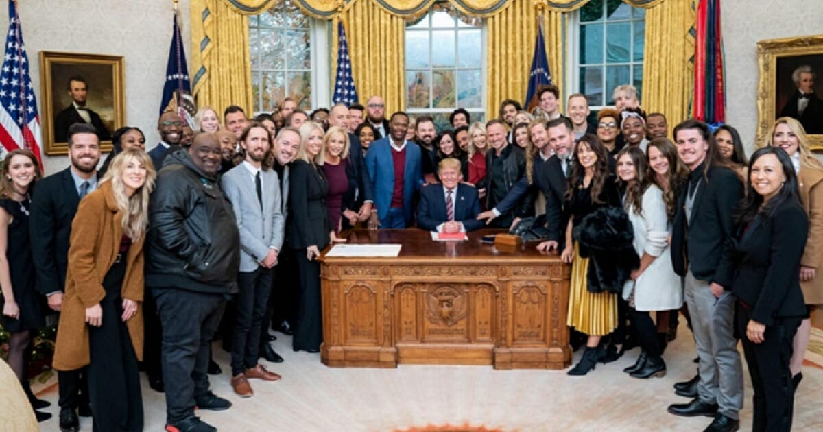 President Donald Trump is surrounded by Christian leaders last week during a prayer session in the White House Oval Office.