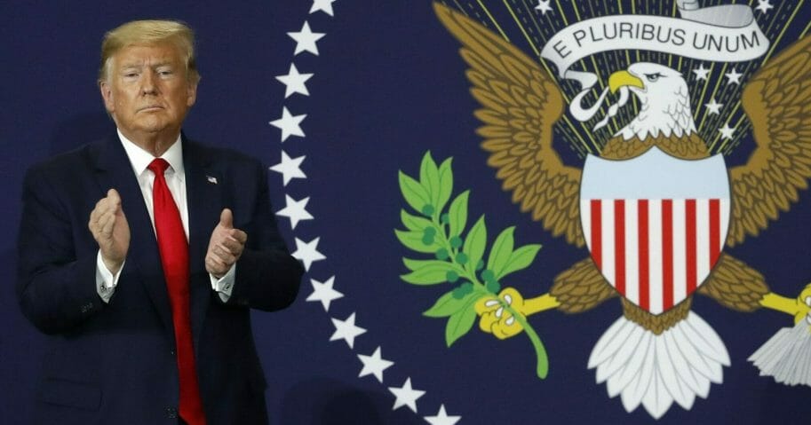 President Donald Trump claps after speaking in Warren, Michigan, on Jan. 30, 2020.