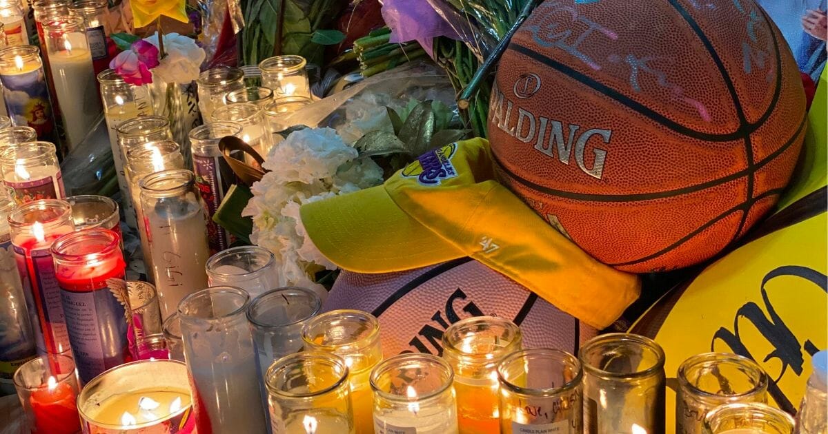 Candles are displayed at a makeshift memorial in front of a mural for former NBA and Los Angeles Lakers player Kobe Bryant in downtown Los Angeles on Jan. 26, 2020, as people pay tribute to the former basketball player following his death in a helicopter crash near Los Angeles.