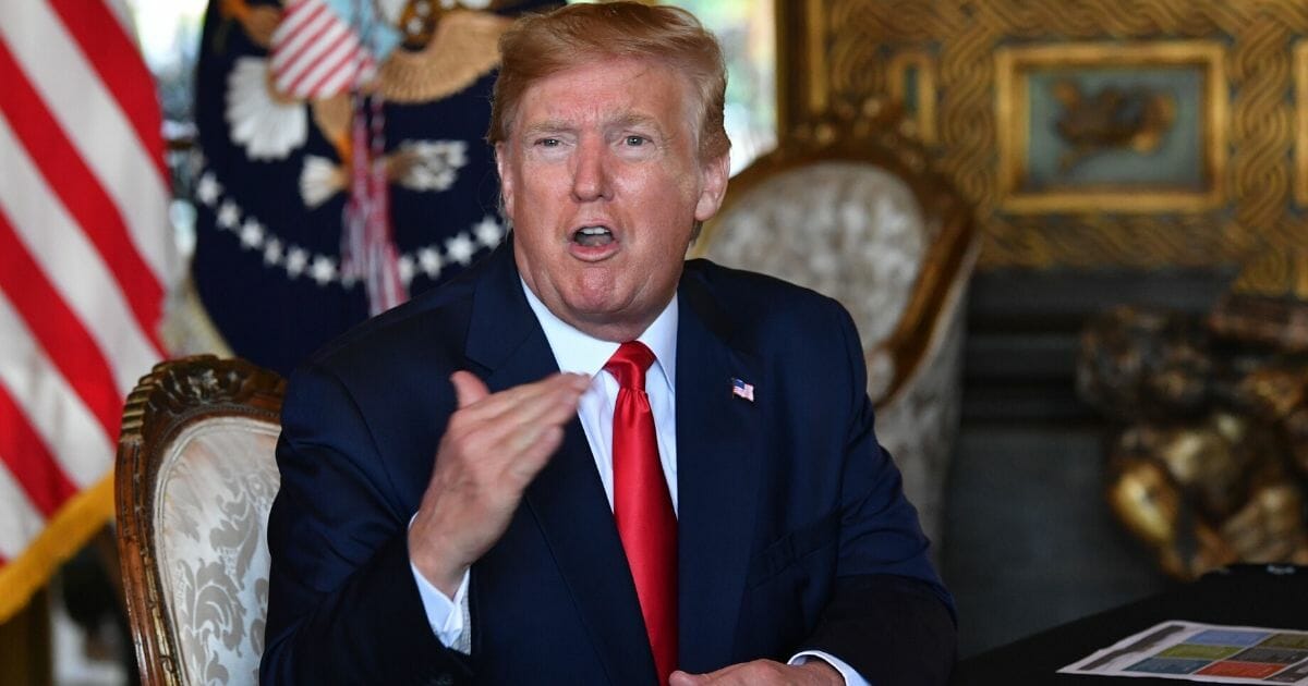 President Donald Trump answers questions from reporters after making a video call to the troops stationed worldwide at the Mar-a-Lago estate in Palm Beach, Florida, on Dec. 24, 2019.
