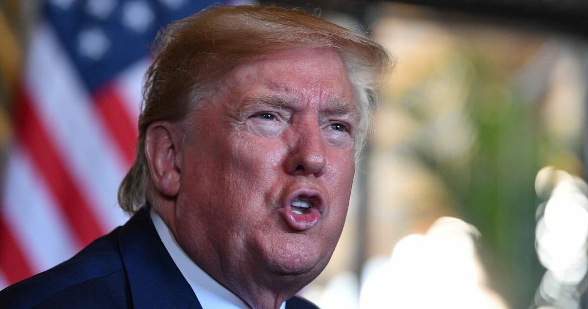 President Donald Trump answers questions from reporters after making a video call to the troops stationed worldwide from the Mar-a-Lago estate in Palm Beach, Florida, on Dec. 24, 2019.