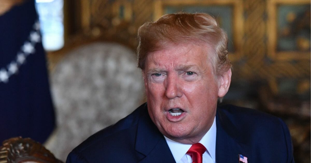 President Donald Trump answers questions from reporters after making a video call to the troops stationed worldwide at the Mar-a-Lago estate in Palm Beach Florida, on Dec. 24, 2019.